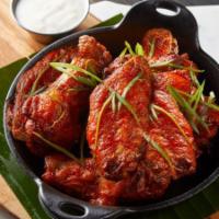 Border Wings · Gigante chicken wings tossed in your choice of Mexican BBQ or spicy wing sauce served with r...