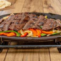 Grilled Steak · With peppers and onions on homemade flour tortillas. Served with Fresh Mex rice, fresh guaca...