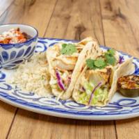 GRILLED FISH TACOS · Two handmade soft flour tortillas filled with grilled fish, chipotle aioli, crisp lettuce, p...