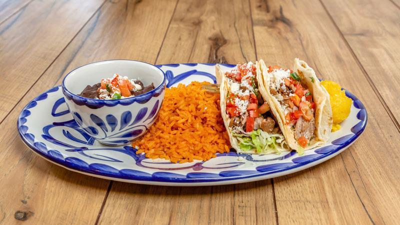 Carnitas Tacos · Two tacos with cabbage slaw, chipotle aioli, pico de gallo, choice of flour or corn tortillas, served with rice and beans