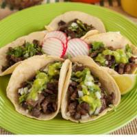 *Taco · A handmade tortilla, meat, cilantro, and onion.