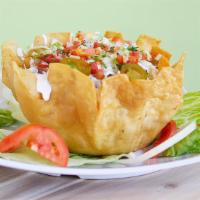 *Taco Salad* · Fried flour tortilla shell, meat, whole beans rice, lettuce, pico de gallo, avocado, and sou...