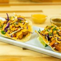 *Fried Fish Taco · Fried tilapia filets served in a crispy tortilla with cabbage slaw and a spicy, tangy chipot...