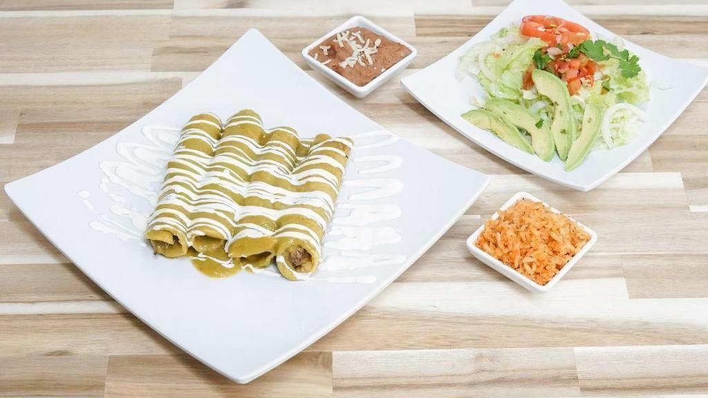 *Enchiladas* · 4 chicken enchiladas, smothered in melted jack cheese and your choice of our house red or green sauce (medium spice). Served with rice, beans, and salad.