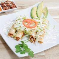 *Flautas* · Shredded chicken or beef wrapped in 4 crispy fried tortillas (think taquitos) topped with le...