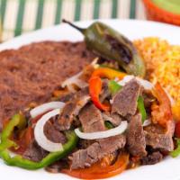 *Bistec Ranchero* · Grilled carne asada with diced bell peppers, onions, tomato, and jalapeno. Served with rice,...