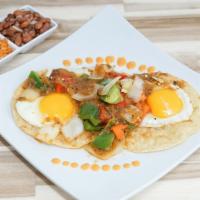 *Huevos Rancheros · Sunny-side up fried eggs, smothered in salsa and grilled bell peppers, served atop a crispy ...