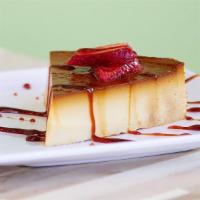 *Flan Napolitano · House-made creamy Mexican custard with a toasted caramel glaze. (Pictured with strawberry to...
