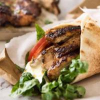 Chicken Shawerma Wrap · Tender marinated chicken thinly sliced, hummus, lettuce, and tahini sauce.