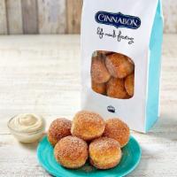 Cinnasweeties™ · 5 cinnamon and sugar donut holes with frosting cup.