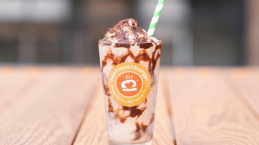 Thicc Mint Cookie Shake · Organic Mint Syrup, Fair Trade Organic Chocolate Syrup & House-Made Gluten-Free Cookie Crumbles Blended into Your Choice of Organic Coconut or Non-GMO Soy Soft Serve.