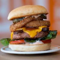 The Maverick Burger · House-Seasoned Beyond Burger Patty, Crispy Onion Rings, Organic Tempeh Bacon, Organic Dill P...