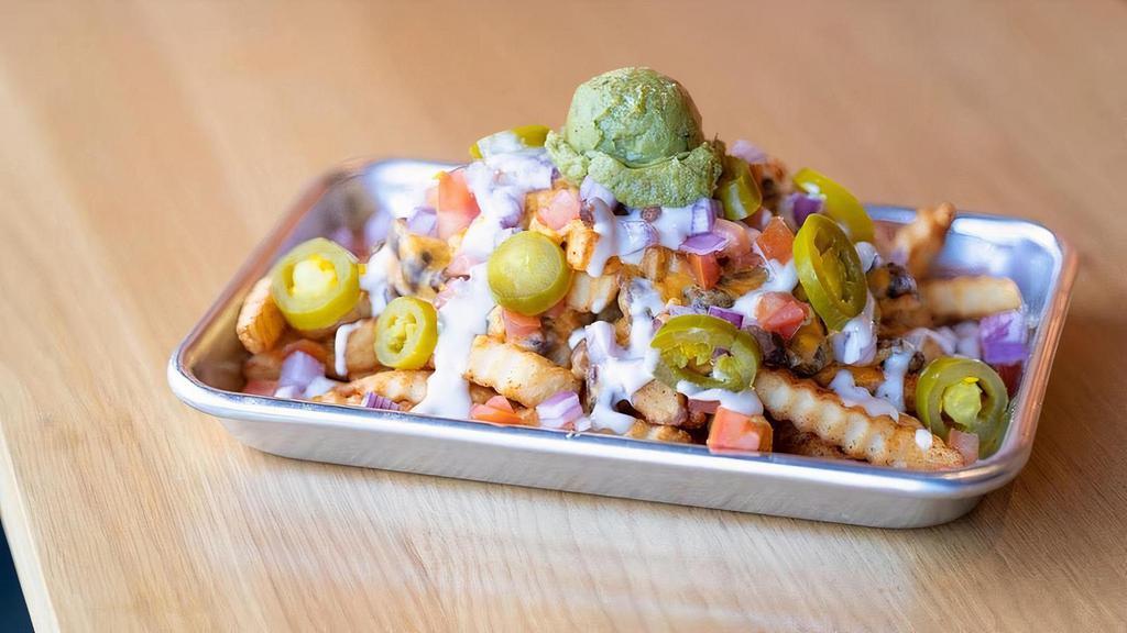 Nach'yo Mama's Fries · Our Fan-Favorite Southwest-inspired fries are back for a Limited Time Only! Featuring Organic Crinkle Cut French Fries, Melty Cheddar Cheese, Organic Black Beans, Organic Onions &  Tomatoes topped with Sour Cream and Organic Guacamole. Ole!