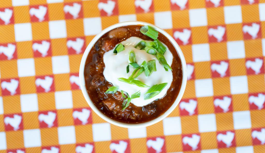 Side Cluckchili · Our House-Made & Organic 3-Bean Chili. Topped with Sour Cream & Organic Green Onions.  Allergies: Sour Cream Contains Cashews.
