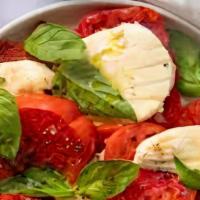 Tomato Caprese · Fresh buffalo mozzarella, sliced heirloom tomato, basil, sicilian olive oil.