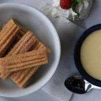 Churro Bites · Served with dulce de leche dipping sauce.