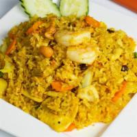 R4. Pineapple Fried Rice · Combination fried rice of prawns and chicken with fresh pineapple, cashew nuts, raisins, car...