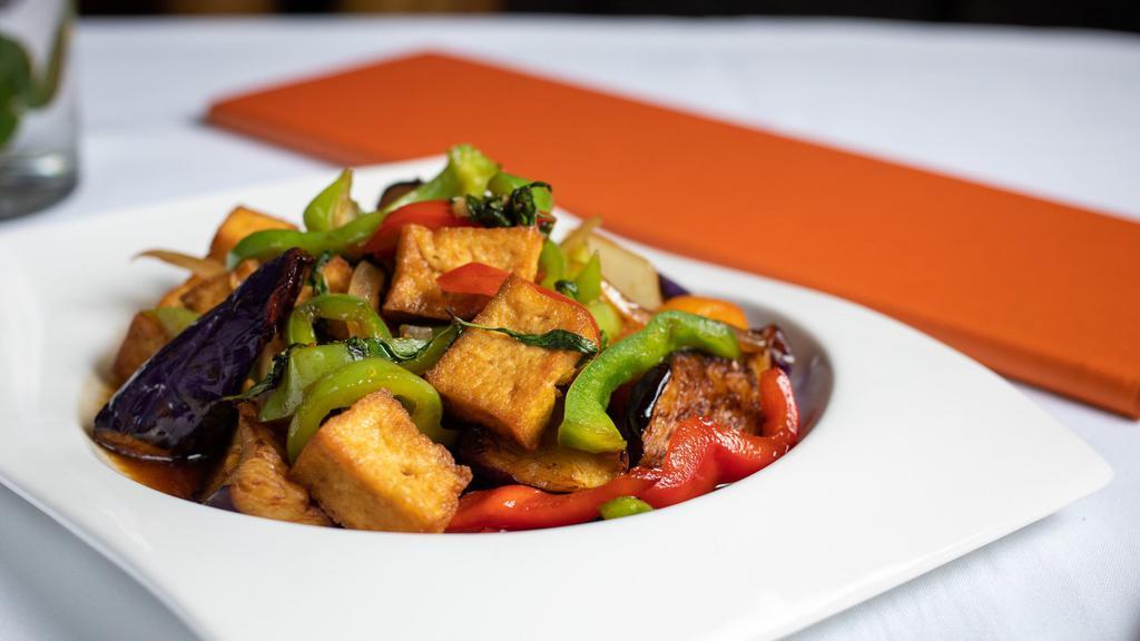 V7. Eggplant with Tofu · Sautéed tofu with eggplant in mild garlic sauce, onion, bell peppers, and fresh basil.