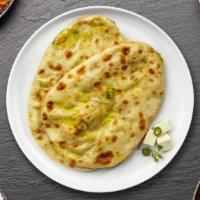 Second To Stuffed Paneer Naan · Freshly baked bread stuffed with minced paneer cooked in a clay oven.