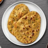 Fire Desire Naan · Freshly baked bread in a clay oven then coated in garlic.