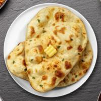 Butter Hustler Naan · Freshly baked bread in a clay oven garnished with butter