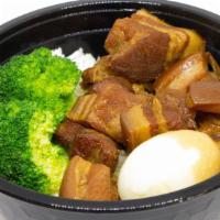 Braised Pork Belly · Slow cooked tendered pork belly served with a soy sauce egg and steamed brocolli