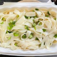 Garlic Noodles · Flat Chinese rice noodles tossed with butter, caramelized garlic and green onions