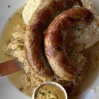 *Bratwurst* · Two Grilled Rustic Pork Bratwurst with Cracked Spices
served over Sauerkraut & Mashed Potato...