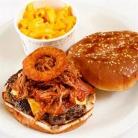 Smokin' Burger · Our juicy bacon cheese burger topped with pulled pork, crispy onion rings and BBQ sauce.