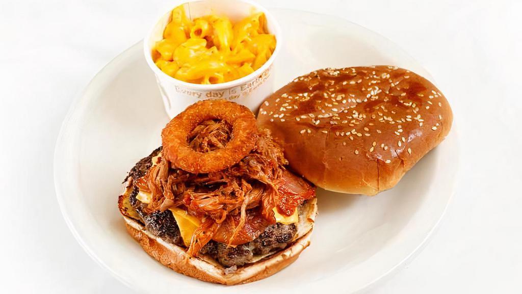 Smokin' Burger · Our juicy bacon cheese burger topped with pulled pork, crispy onion rings and BBQ sauce.