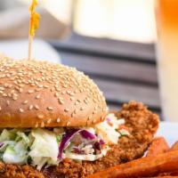 FRIED CHICKEN SANDWICH · fried chicken breast topped with coleslaw and sweet sriracha sauce on a toasted sesame brioc...