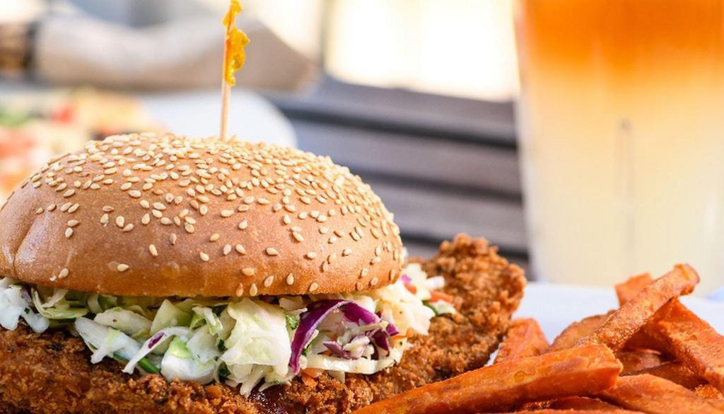 FRIED CHICKEN SANDWICH · fried chicken breast topped with coleslaw and sweet sriracha sauce on a toasted sesame brioche bun