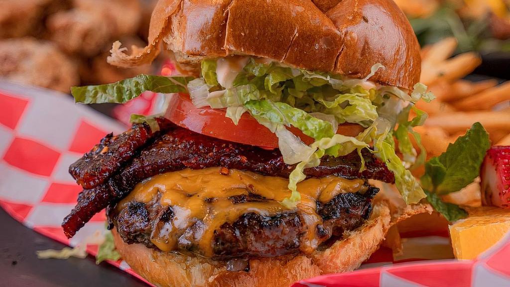 Millionaire’s Burger · Spicy. housemade wagyu patty, Millionaire’s bacon, tomato, mild cheddar, romaine.