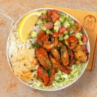 Chicken Shawarma Rice Bowl · Savory chicken shawarma over basmati rice with hummus, diced cucumber and tomato salad, shre...