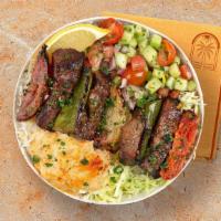 Beef Skewer Rice Bowl · Grilled beef over basmati rice with hummus, diced cucumber and tomato salad, shredded green ...
