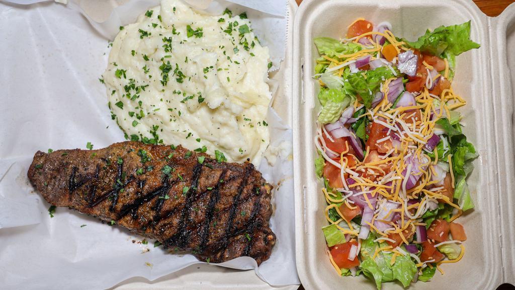 NY Steak and Potatoes · Served with a baked potato and salad.
