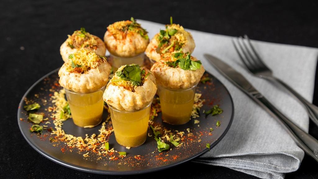 Pani Puri Shots · Hollow fried shells stuffed with potato, onion, and chickpeas. Served with a mixture of sweet and spicy chutneys in shot glasses.