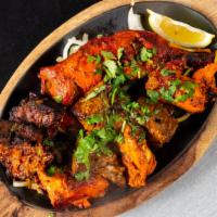 Mix Grill · An all meat assortment including chicken boti, beef boti, lamb chops, and tandoori chicken.