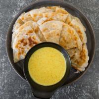 Paratha w/ Coconut Curry Dip · Burmese version of a crispy pancake! Flaky & buttery layered bread served with homemade coco...
