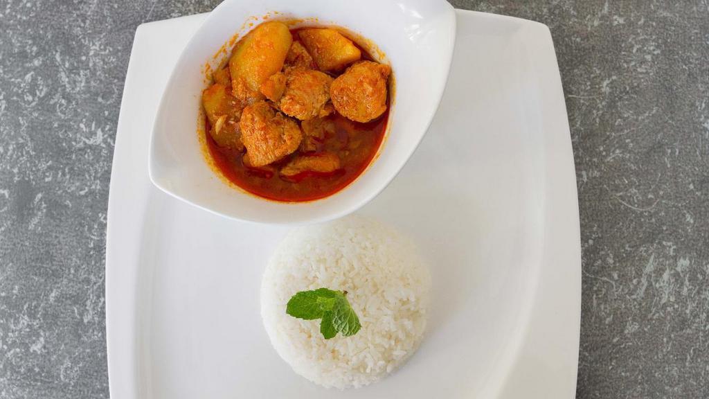 Chicken Curry · Cubed chicken cooked with potatoes, garlic, onion, ginger, chili paste, turmeric and authentic homemade Burmese curry spices.