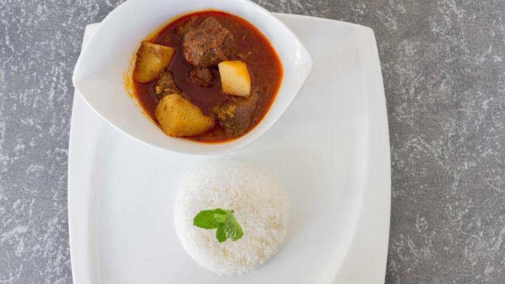 Beef Curry · Slow-cooked cubed beef stew with potatoes, garlic, onion, ginger, chili paste, turmeric and authentic Burmese curry spices.