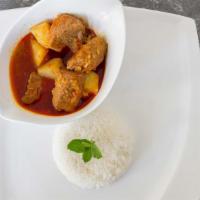 Pork Curry · Cubed pork cooked with potatoes, garlic, onion, red chili paste, turmeric & tamarind puree.
