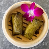 Wrapped Sticky Rice · Steam Sticky rice with banana & black bean wrap in banana leave