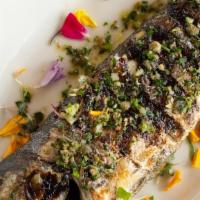 Branzino · filet of Mediterranean sea bass, herb dressing, roasted potatoes, fennel, and red onion.