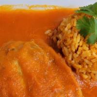 Chile Rellenos · Chili poblano stuffed with fresh cheese bathed in tomato sauce with rice, beans and corn tor...