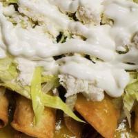 Tacos Dorados · Beef, green salsa, lettuce, fresh cheese, and sour cream.