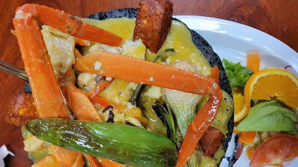 Molcajete De Mariscos · Hot molcajete filled with house spice salsa, sea food, mix with crab and garlic bread.