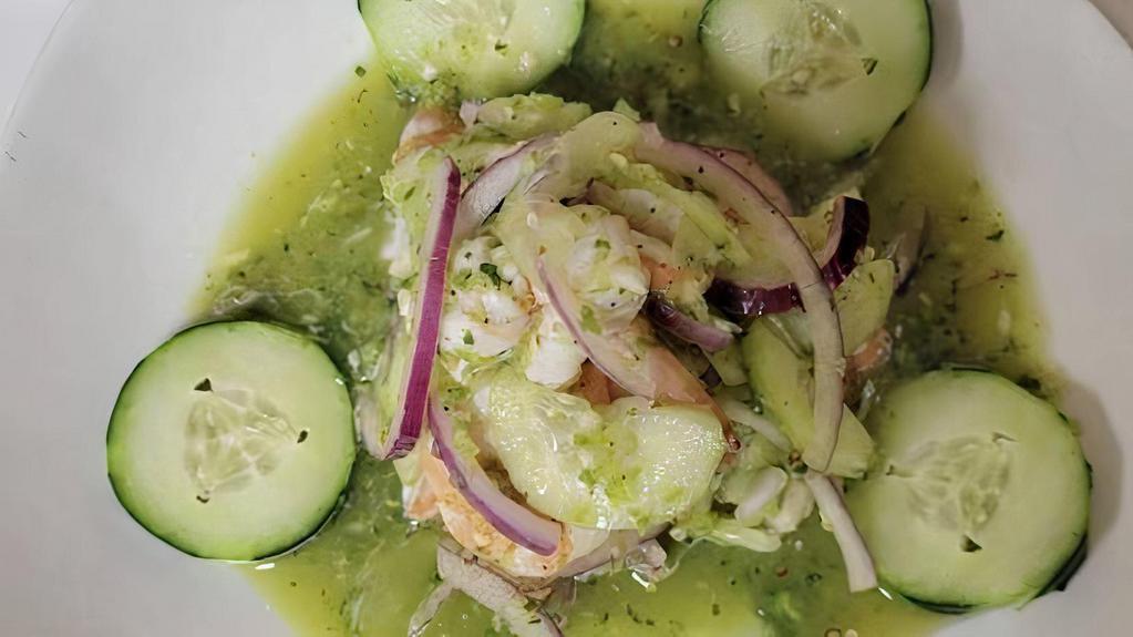 Aguachiles · Succulent shrimp marinated in a delicious and spicy green chile sauce, chili peppers, lime juice, cilantro, slices of cucumber and slices of onion.