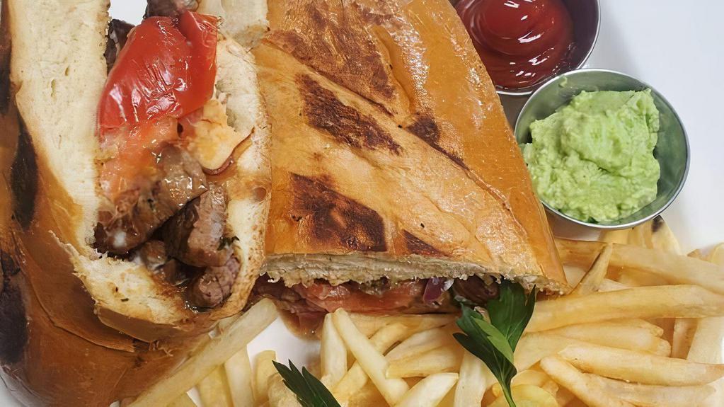 Torta · Choice of meat, fried beans, salsa chipotle, onion, tomatoes, lettuce, avocado, mayonnaise.