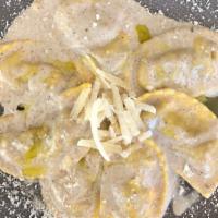 Mezzelune ai Porcini · Homemade Ravioli stuffed with porcini mushrooms and cheese, served in a tasty and creamy bla...